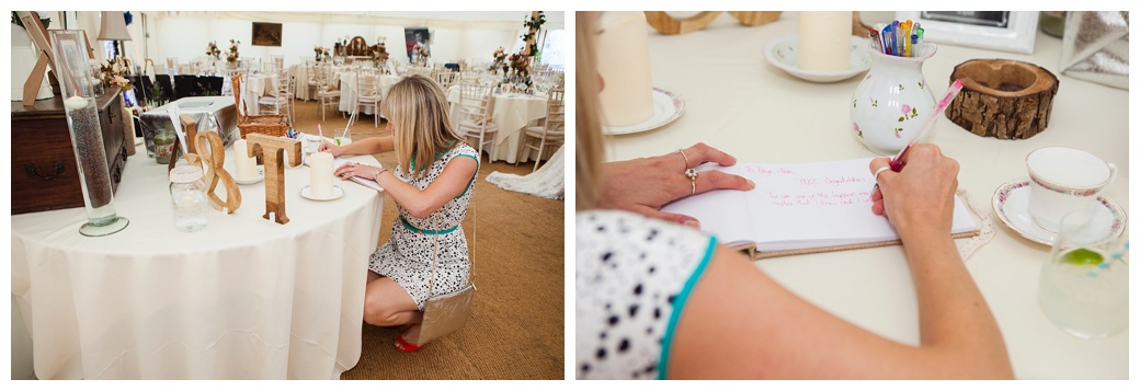 guest writing in book for bride and groom